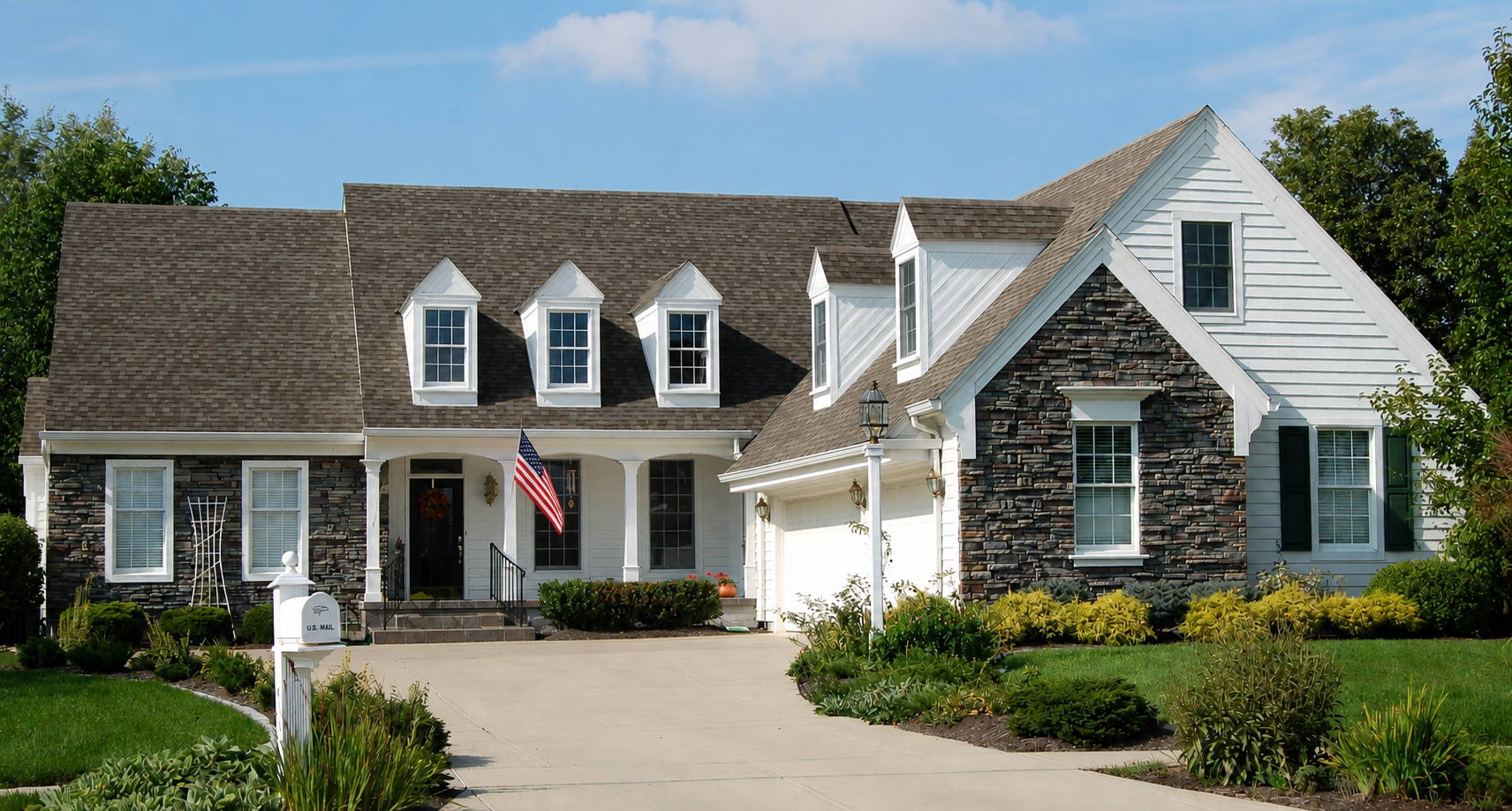 Clean residential home with pristine white gutters and downspout